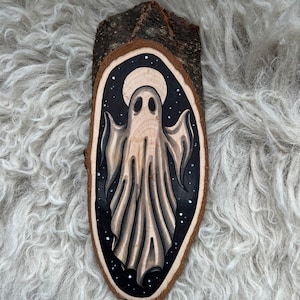 Tranche de bois avec un dessin original d'un fantôme avec une lune