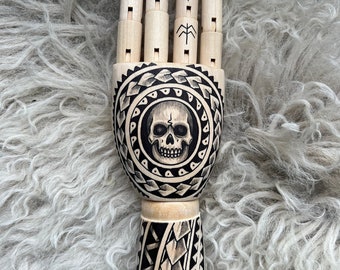 Wooden hand with a skull and polinesian tattoo design