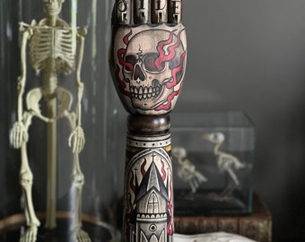 Wooden arm and hand with skull and burning church tattoo design