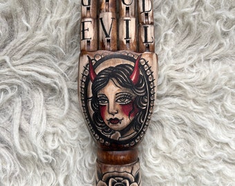 Vintage wooden hand with a woman and horns tattoo design