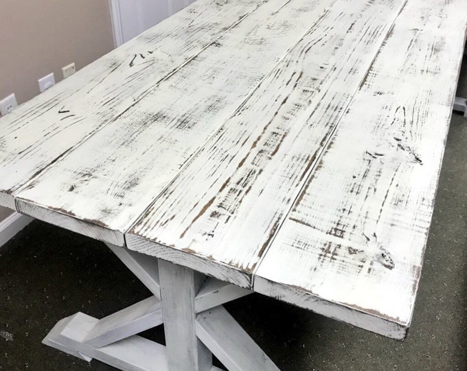 Weathered White Pedestal Farmhouse Table whith Distressed White Trestle Base and Weathered Top with Dark Walnut Showing Through Dining