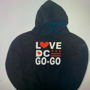 May include: Black hooded sweatshirt with white text that reads "LOVE DC GO-GO" with a red heart and a red arrow pointing to the right.