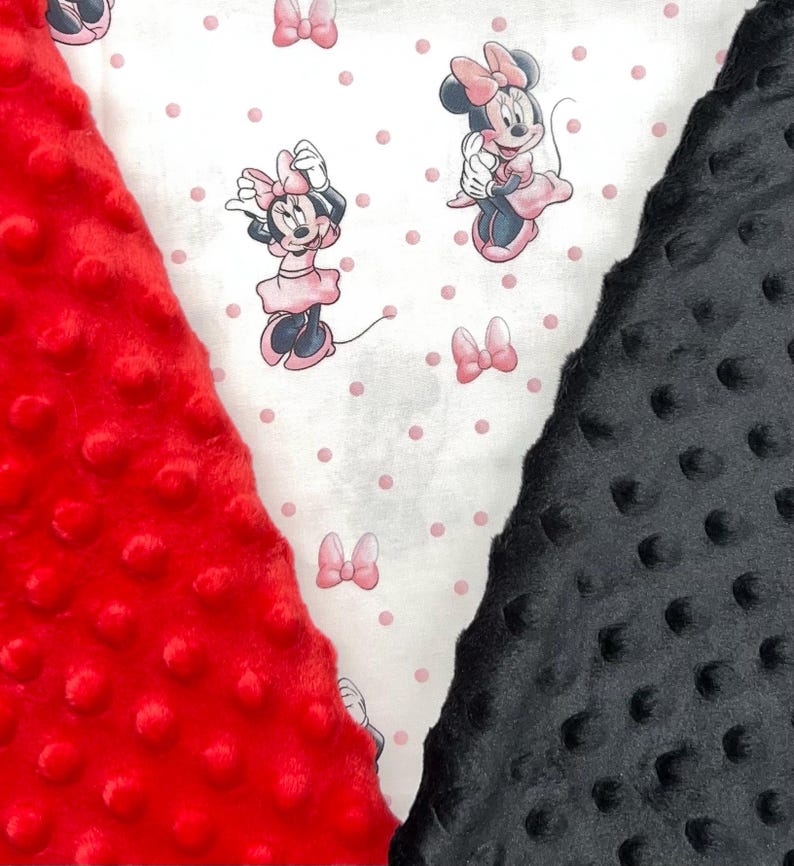 K&ouml;nnte beinhalten: Nahaufnahme von drei verschiedenen Stoffen. Links ein roter, strukturierter Stoff mit einer unebenen Oberfl&auml;che. In der Mitte befindet sich ein wei&szlig;er Stoff mit einem Minnie-Maus-Muster und rosa Punkten. Rechts ist ein schwarzer, strukturierter Stoff.