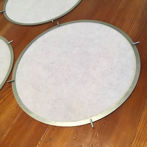 May include: Three white round fabric lampshades with silver metal rims and screws.