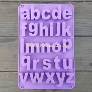 May include: A lilac silicone alphabet mould with lowercase letters in a rounded font. The text "Daily Proposal USA" is printed across the center. This mould is suitable for crafting or baking projects. The letters are in a bold font.