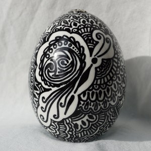Duck egg art.  Oil paint pen.  Butterfly Egg art reminiscent of Pysanky Ukrainian Egg.  Mehndi design.  Two butterflies in foilage.  USA