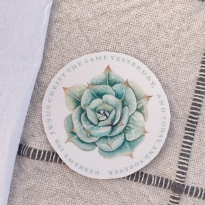 May include: A round sticker with a green succulent illustration and the text "Jesus Christ is the same yesterday, and today, and forever. Hebrews 13:8"
