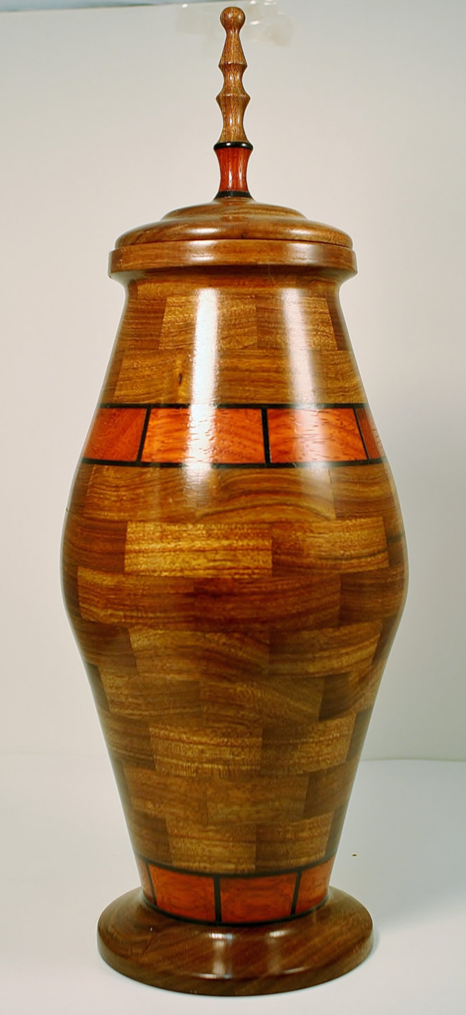This Hand Crafted Segmented Urn is Made With Chechen,paduak,gaboon