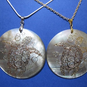 Elegant Sea Turtle reversible with goldtone or silver bail on 2" round Abalone Shell, pendant on 18" 925 stamped silver or goldtone chain.