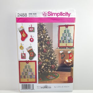May include: A Simplicity sewing pattern for a Christmas tree quilt with a stocking and picture frame ornaments. The pattern is for one size and is by Leslie Asch.