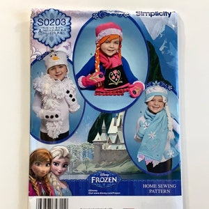 May include: A sewing pattern for making Frozen-themed costumes for children. The pattern includes instructions for making a snowman costume, an Elsa costume, and an Anna costume. The pattern is from Simplicity and is designed and printed in the USA.