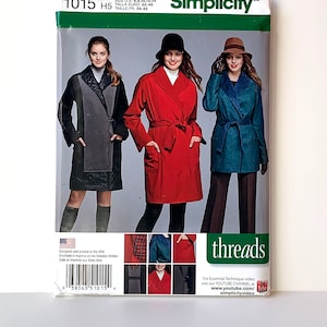 May include: Simplicity sewing pattern number 1015 H5 for a coat. The pattern includes three different styles: a red coat with a belt, a blue coat with a collar, and a gray coat with a contrasting collar. The pattern is designed for sizes 6-14, 34-42.