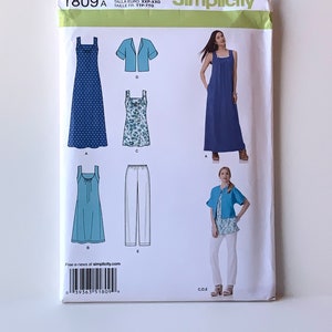May include: Simplicity sewing pattern number 1809 A for sizes XXS-XXL. The pattern includes instructions for making a maxi dress, a shorter dress, a top, trousers, and a jacket. The pattern is printed on white paper with blue and white illustrations of the garments.
