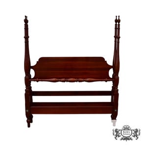May include: A dark reddish-brown wooden bed frame featuring a tall headboard with a curved top edge. The frame includes four vertical posts with turned detailing and a horizontal rail with decorative spindle accents connecting the two front posts.