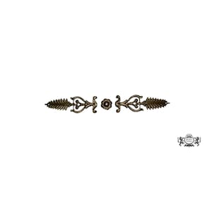 May include: Ornate bronze-colored decorative metal element. The design features symmetrical floral and leaf motifs, with a central flower and stylized leaf shapes extending outwards. The piece is set against a white background.