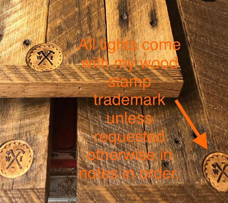 May include: Close-up of a wooden surface with a brown stamp that says "W & E" with two crossed hammers. The text "All lights come with my wood stamp trademark unless requested otherwise in notes in order." is visible in the image.