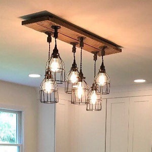 THE STEEL WORKER  industrial pipe fitting  cage pendant barn wood chandelier