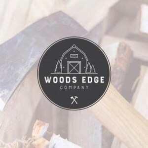 May include: Black and white logo for Woods Edge Company, featuring a stylized image of a cabin with trees and an axe. The logo is on a black circle with a white outline.