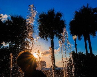 Photograph "Splash of Color" - Florida sunset as a child plays in the fountains of Winter Garden - a range of sizes and media