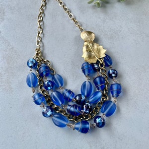 Blue and gold multistranded beaded repurposed necklace with metal wire detail | vintage brooches