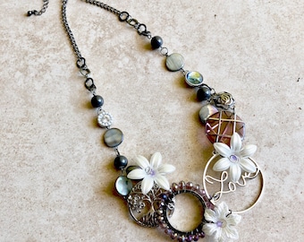 Purple and white floral statement necklace made from repurposed beads and trinkets