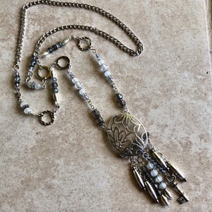 Handmade repurposed long silver dangle necklace with gray irridescent beads and decorative charms