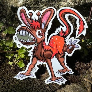 May include: A cartoon illustration of a red and brown creature with large ears, sharp teeth, and a long tail. The creature is standing on all fours and has a menacing expression.