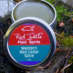May include: A small tin of Western Red Cedar Salve, labeled "Red Turtle and the Plant Spirits". The salve is a deep green color and the tin is silver with a red, green, and purple label.
