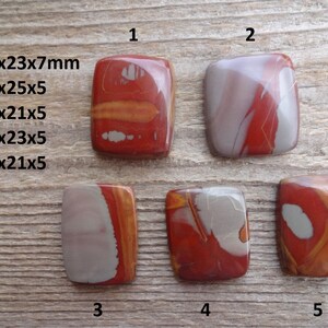 May include: Five red, white, and gray polished stone cabochons, each with a unique pattern. The stones are rectangular and measure approximately 2.5 cm by 3 cm. The stones are numbered 1 through 5.