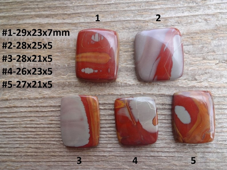 May include: Five red, white, and gray polished stone cabochons, each with a unique pattern. The stones are rectangular and measure approximately 2.5 cm by 3 cm. The stones are numbered 1 through 5.