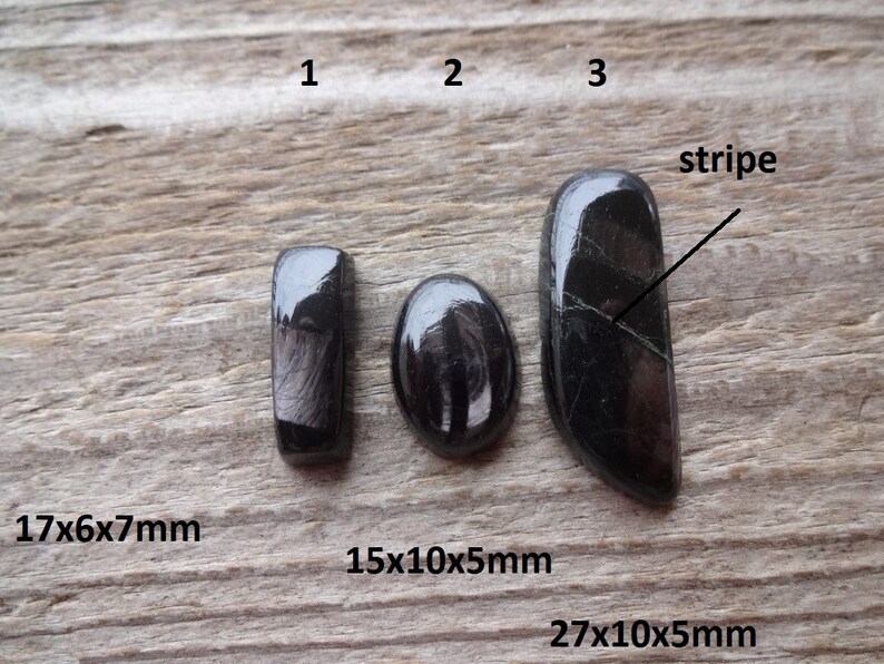 May include: Three black cabochon gemstones with a stripe pattern. The gemstones are labeled 1, 2, and 3. The measurements are 17x6x7mm, 15x10x5mm, and 27x10x5mm.