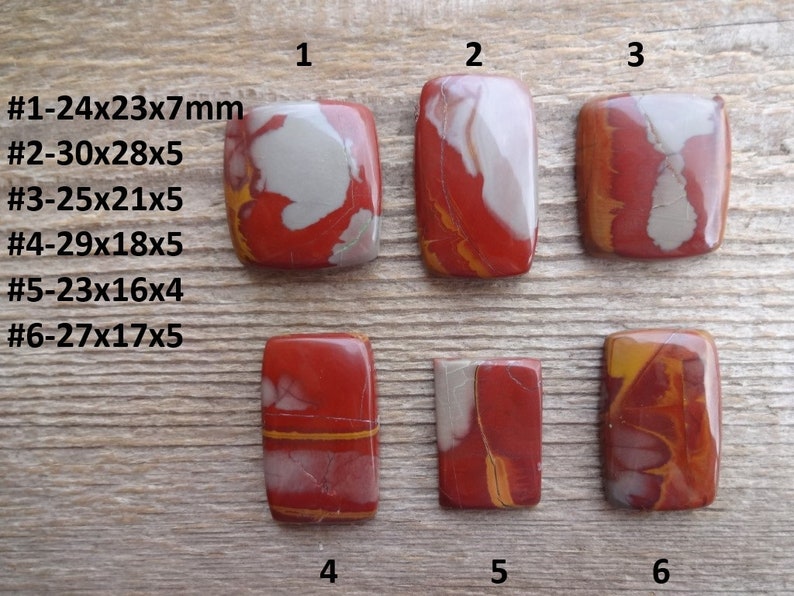 May include: Six polished red, white, and yellow jasper cabochons, each with a unique pattern. The cabochons are numbered 1 through 6, and their dimensions are listed below each number. #1-24x23x7mm #2-30x28x5 #3-25x21x5 #4-29x18x5 #5-23x16x4 #6-27x17x5