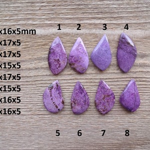 May include: Eight purple and white cabochon stones in a teardrop shape, arranged in two rows of four. The stones are labeled with numbers 1 through 8. The stones are approximately 15 to 32 millimeters in size.