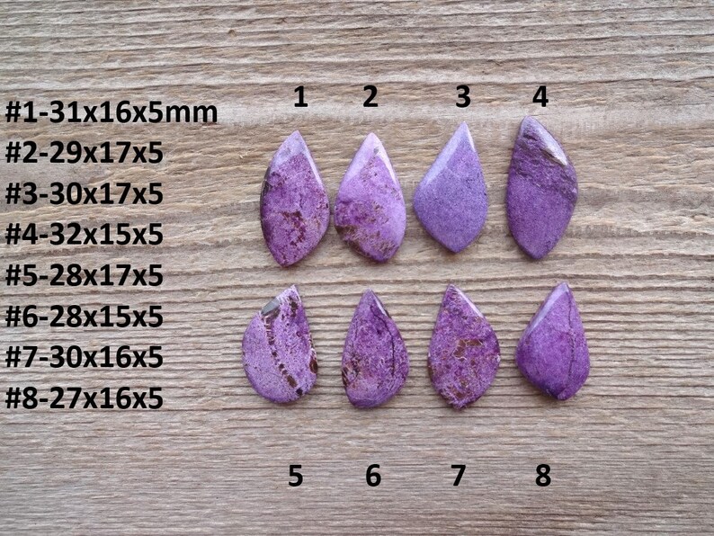 May include: Eight purple and white cabochon stones in a teardrop shape, arranged in two rows of four. The stones are labeled with numbers 1 through 8. The stones are approximately 15 to 32 millimeters in size.
