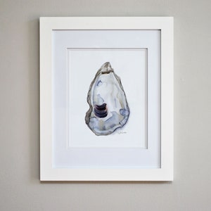 May include: A framed watercolor painting of a single oyster shell with a blue and white interior. The shell is painted in a realistic style and has a subtle texture.