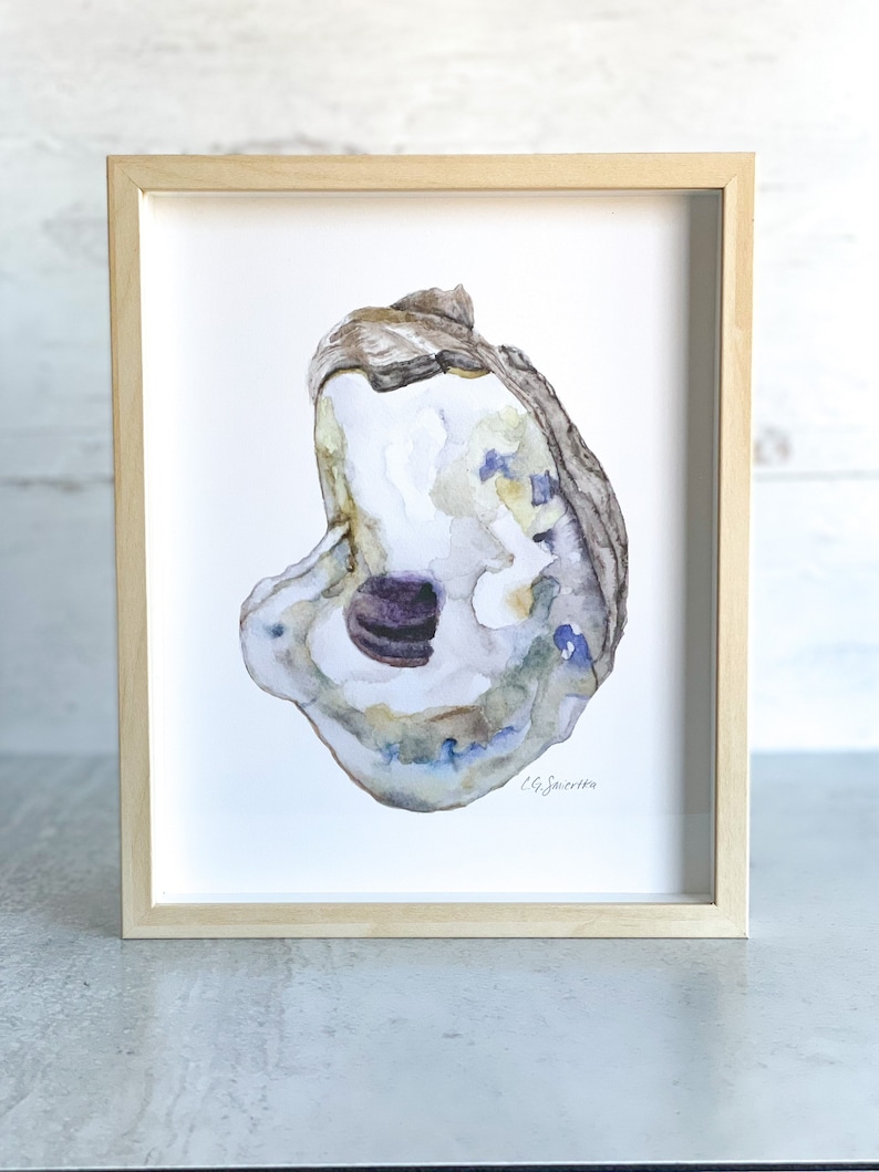 May include: A watercolor painting of an oyster shell with a purple pearl inside. The shell is painted in shades of blue, green, and brown. The artist's signature, "C.G. Sawyers", is in the bottom right corner.