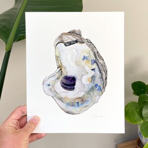 May include: Watercolor painting of an oyster shell with a purple interior. The shell is painted in shades of gray, blue, and yellow. The painting is signed "C.S.Pierce" in the bottom right corner.