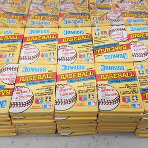 May include: A stack of yellow and red baseball card packs featuring Willie Stargell. Each pack has a baseball graphic and the text "Win Instantly Over 2,000,000 Prizes".