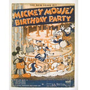May include: A vintage sheet music cover featuring Mickey Mouse and his friends celebrating a birthday party. The cover is illustrated with Mickey Mouse, Donald Duck, Pluto, and two pigs. The text on the cover reads "The New Song Hit Mickey Mouse's Birthday Party".