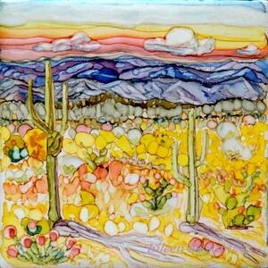 May include: A painting of a desert landscape with a sunset in the background. The foreground features a field of yellow and orange flowers with two tall cacti in the center. The sky is a mix of pink, orange, and yellow.