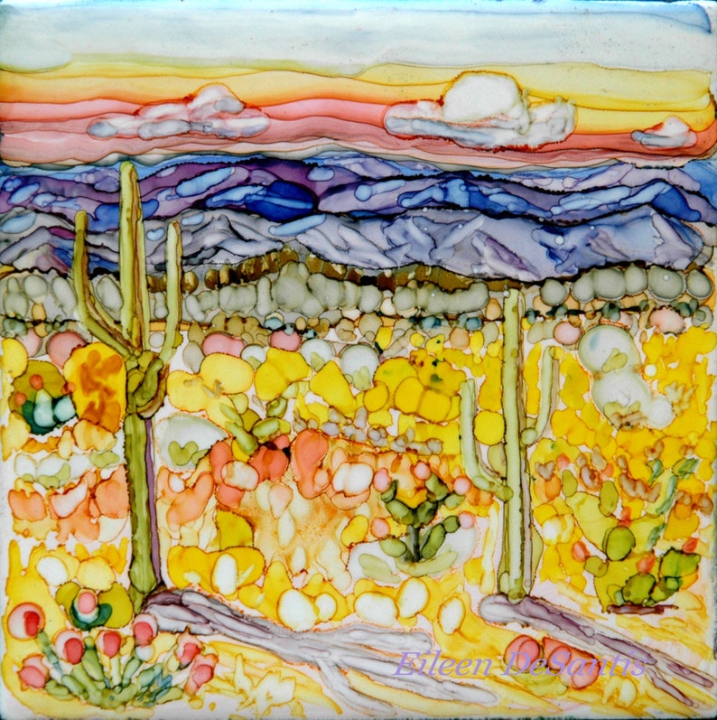 May include: A painting of a desert landscape with a sunset in the background. The foreground features a field of yellow and orange flowers with two tall cacti in the center. The sky is a mix of pink, orange, and yellow.