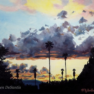 May include: A painting of a sunset with palm trees silhouetted against a cloudy sky. The sky is a mix of pink, orange, yellow, and blue. The clouds are dark gray and white. The palm trees are black. The painting is signed "Eileen DeSantis" in the bottom left corner and "ECD DeSantis 2013" in the bottom right corner.