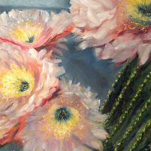 May include: An oil painting depicting several pale pink cactus flowers with yellow centres and a green cactus stem. The painting has a soft, impressionistic style with visible brushstrokes. The artist's signature, "Eileen DeSantis," is in the bottom left corner.