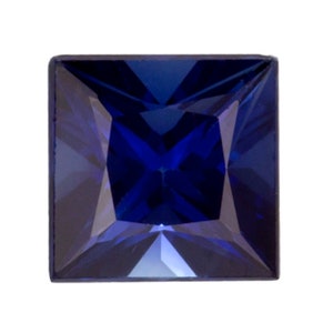 May include: A deep blue square-shaped gemstone with a faceted cut.