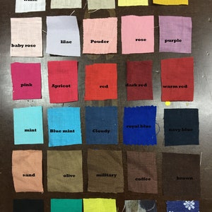 May include: A collection of fabric swatches in various colors, including white, pink, red, blue, and green. Each swatch is labeled with its color name, such as "white," "red," and "navy blue." The swatches are arranged in rows and columns.