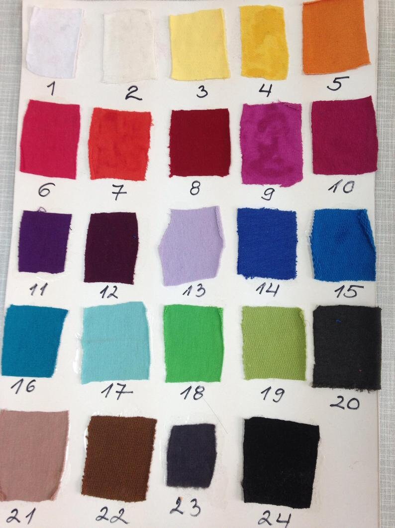 May include: A color swatch chart featuring 24 fabric samples in various colors, including white, yellow, orange, red, purple, blue, green, and black. Each swatch is numbered from 1 to 24.