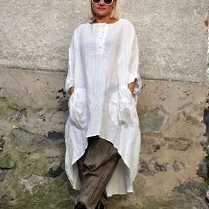 The white tunic is made from linen in oversized fit.