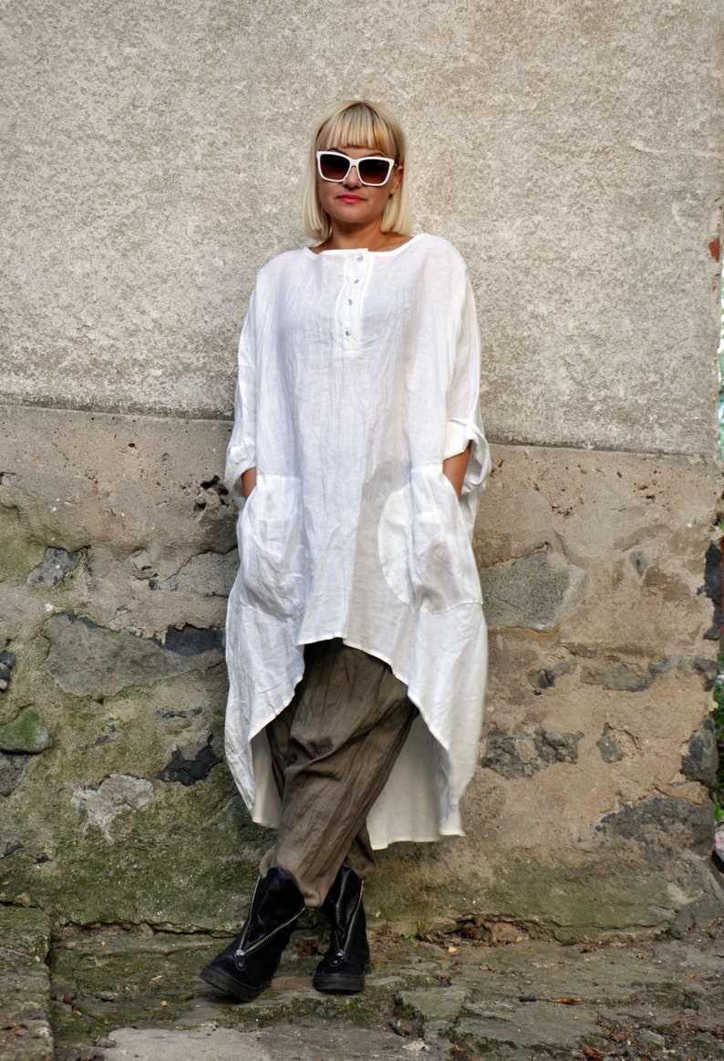 The white tunic is made from linen in oversized fit.