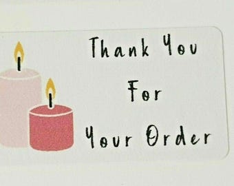 May include: Thank you for your order sticker with two candles, one pink and one red, with flames.