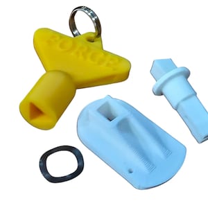 May include: A selection of 3D-printed components. A yellow key with "FORCE" text, a white cylindrical part, a light blue housing, and a black washer are visible. The items are arranged on a white surface.
